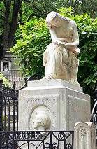 Chopin's tomb at Pre-Lachaise, Paris with Clsinger's monument of a weeping woman (Jenny Lind, says Icons of Europe).